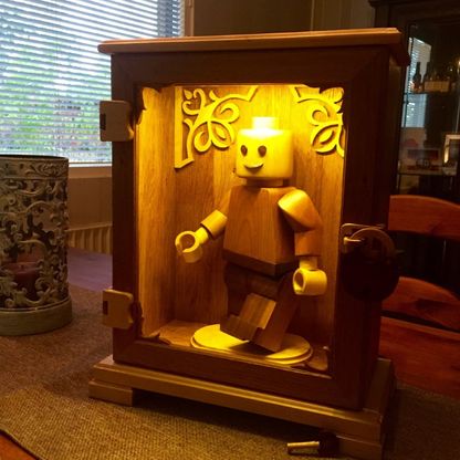 Wood Art Finland – Lego Man in a wooden cabinet